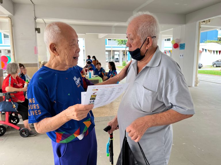 A male volunteer encouraging a senior to join the Centre’s active ageing programmes A male volunteer encouraging a senior to join the Centre’s active ageing programmes
