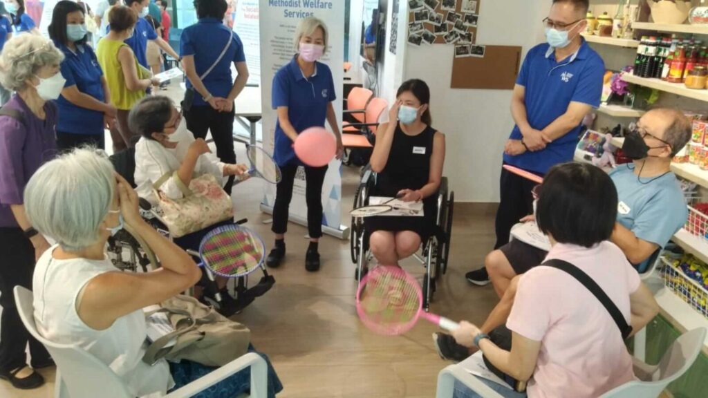 An MWS staff member guiding volunteers on how to conduct an adaptive sports activity
