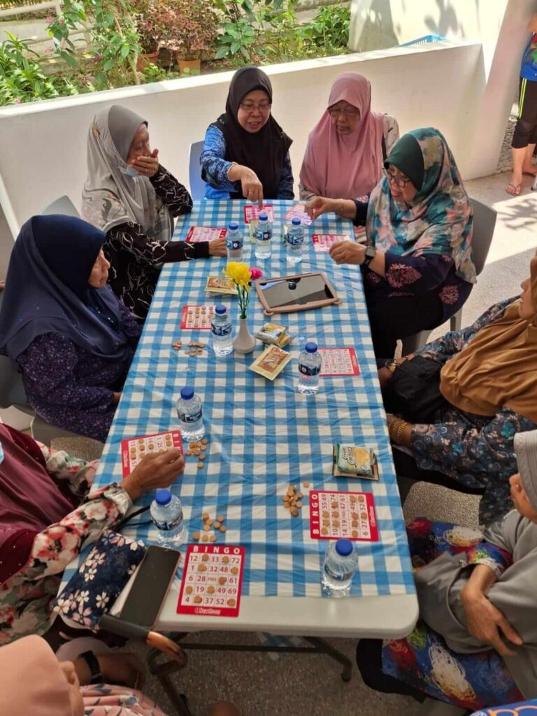 The Malay seniors enjoying a game of bingo together.