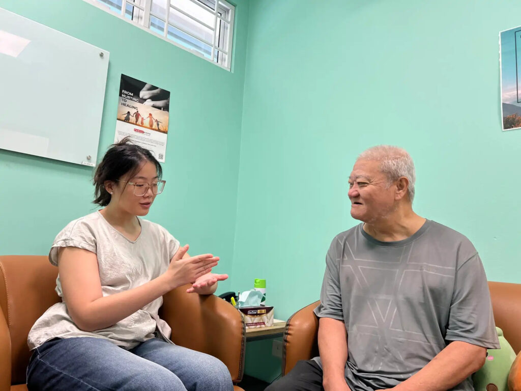 Woo Hong Liang, a beneficiary of Thye Hwa Kwan Moral Charities, with his social worker Eva Lui