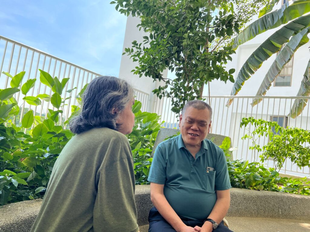 Volunteer Peter Lim with Zarinah Binte Daros, a resident at MWS Nursing Home – Yew Tee