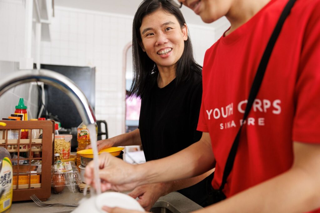 Wendy and Aiden interacting together while washing the dishes