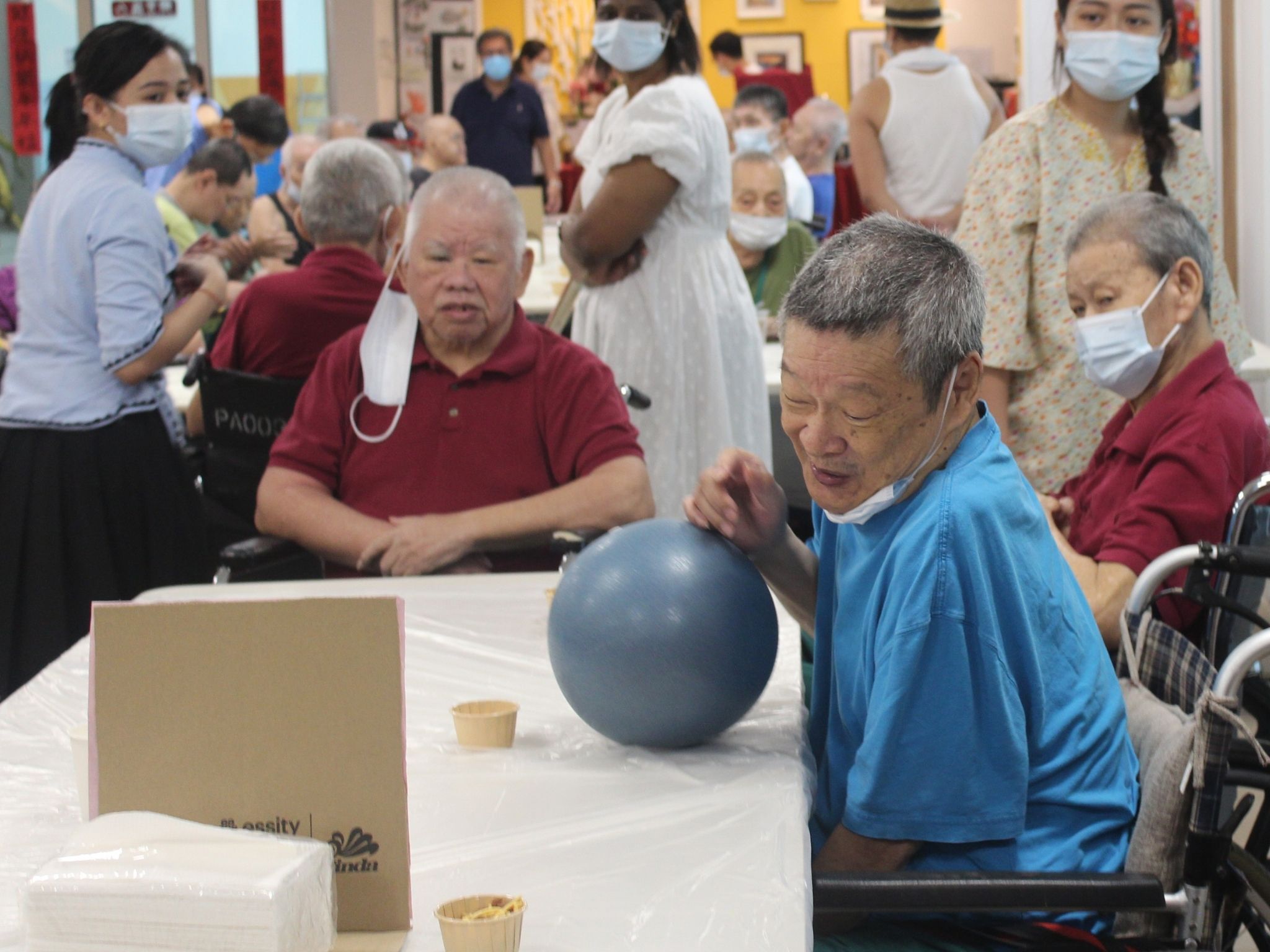 Residents enjoying a ball game during a kampung-themed bazaar.