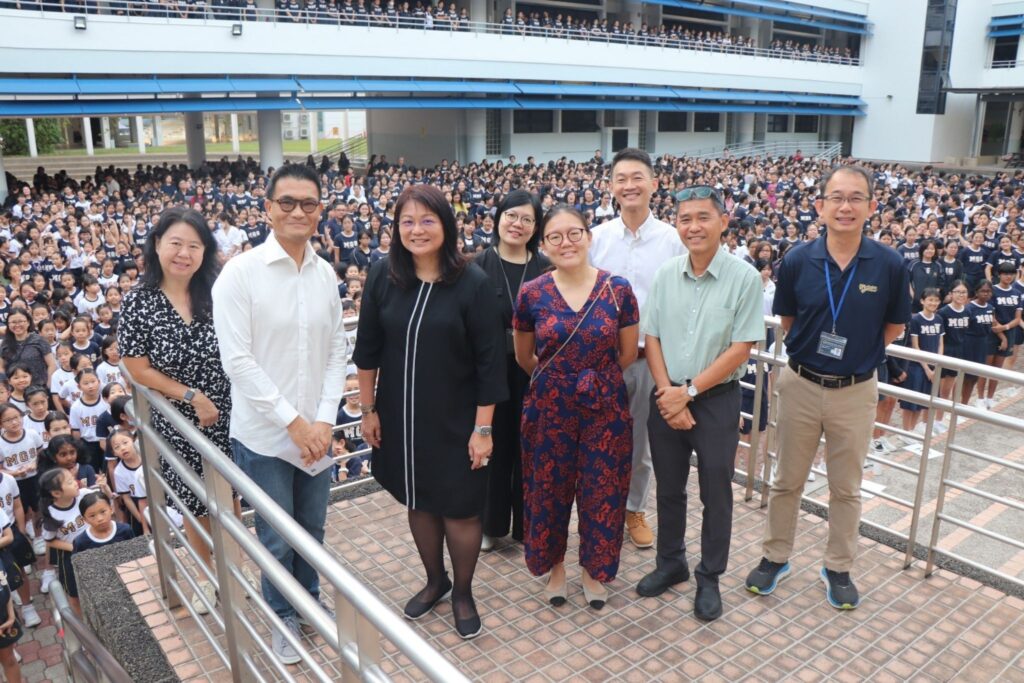 MWS CEO Calvin Ngo with MGS Principal Pamela Yoong (second and third from left) during a school assembly.