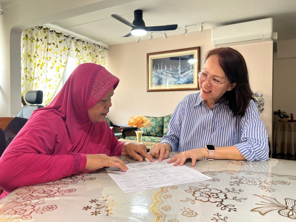 Valerie briefing Mdm Fatimah, a Goodlife Studio (Bedok) member, on upcoming activities and programmes.