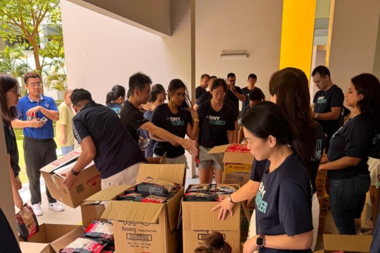 Volunteers packing food rations for distribution.