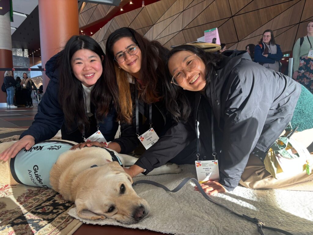 From left: Merci, Thanya, and Pamela enjoying a calming moment with an on-site therapy dog