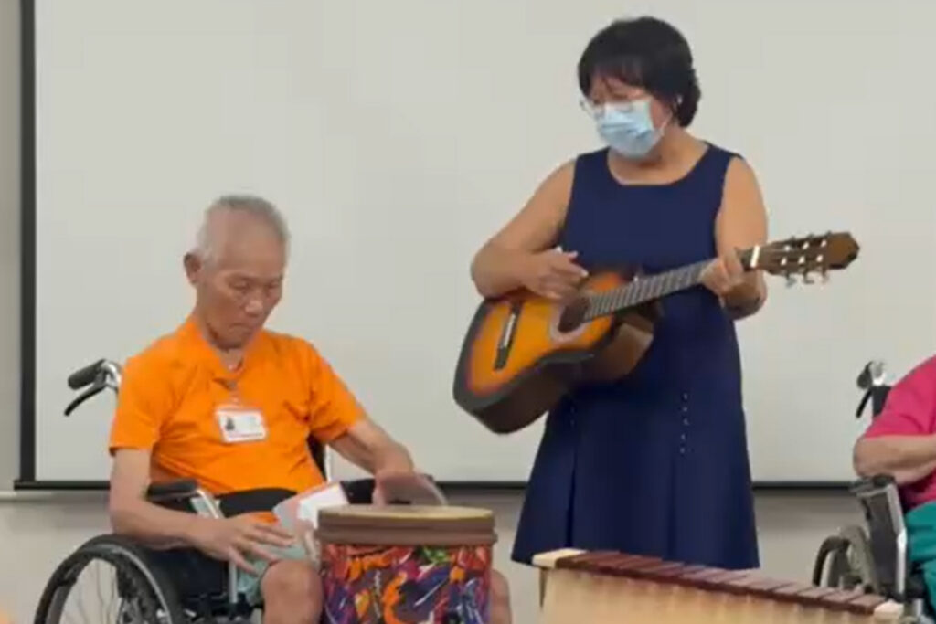 A resident playing a hand drum